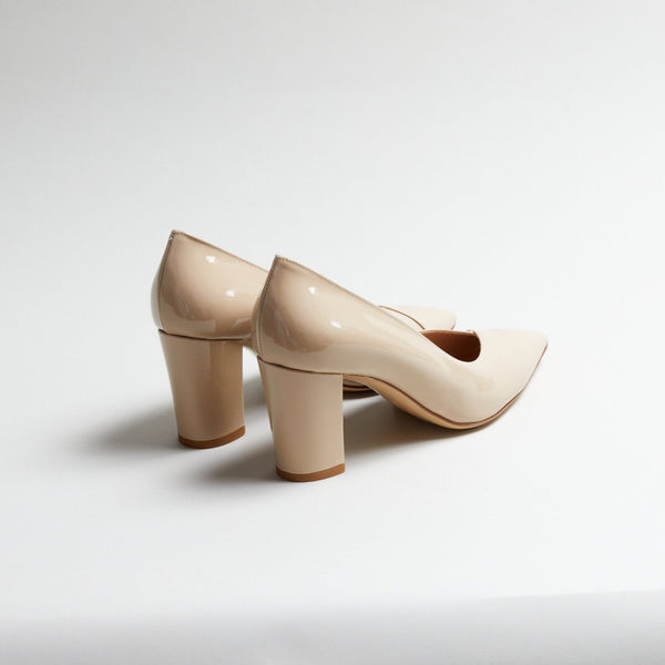 Pair of Luna Selene nude block-heeled pumps on a light gray background