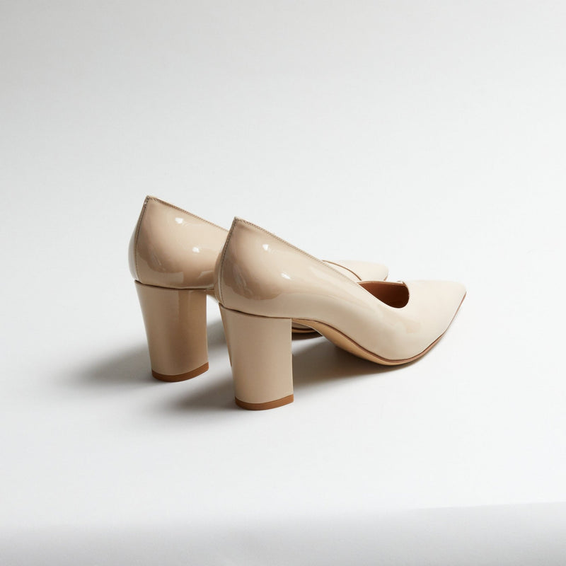 Pair of Luna Selene nude block-heeled pumps on a light gray background
