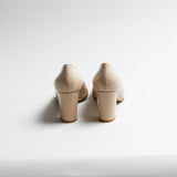 Pair of Luna Selene nude block-heeled pumps on a light gray background