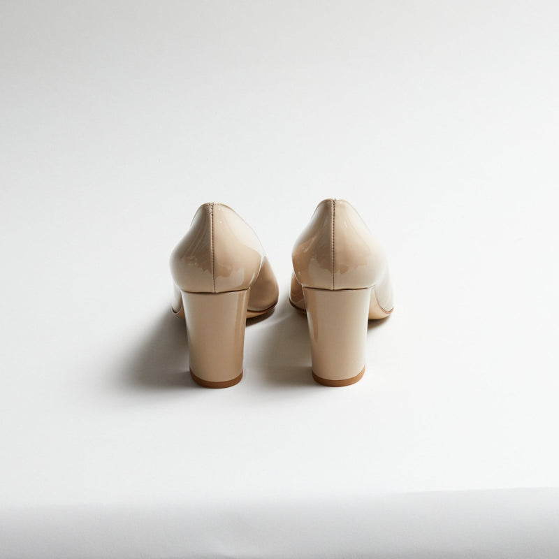 Pair of Luna Selene nude block-heeled pumps on a light gray background