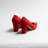 Red Luna Selene block heel pumps on a light gray background