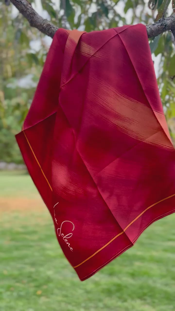 Video of Luna Selene Red silk scarf flowing in the wind. 