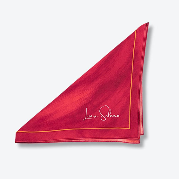 Red and pink Luna Selene silk scarf on a light grey background. 