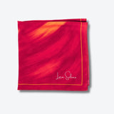 Red and pink Luna Selene silk scarf on a light grey background. 